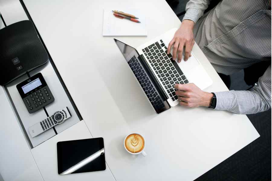 man typing on a laptop