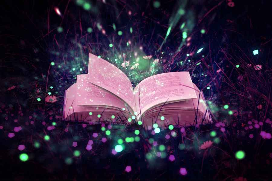 book surrounded by colorful sparkles